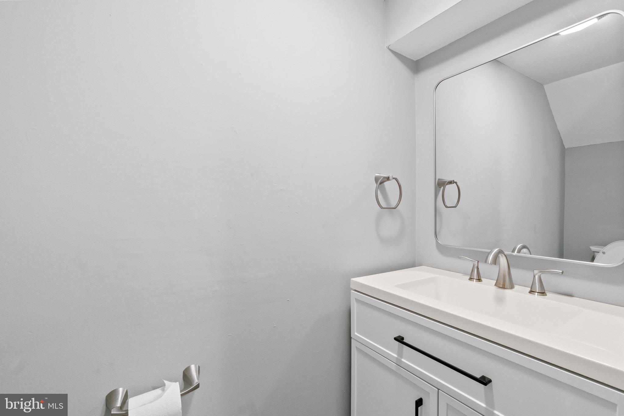 2214 Hawthorne Road Baltimore, MD 21220 - Photo 24 of 28 a bathroom with a sink and a mirror