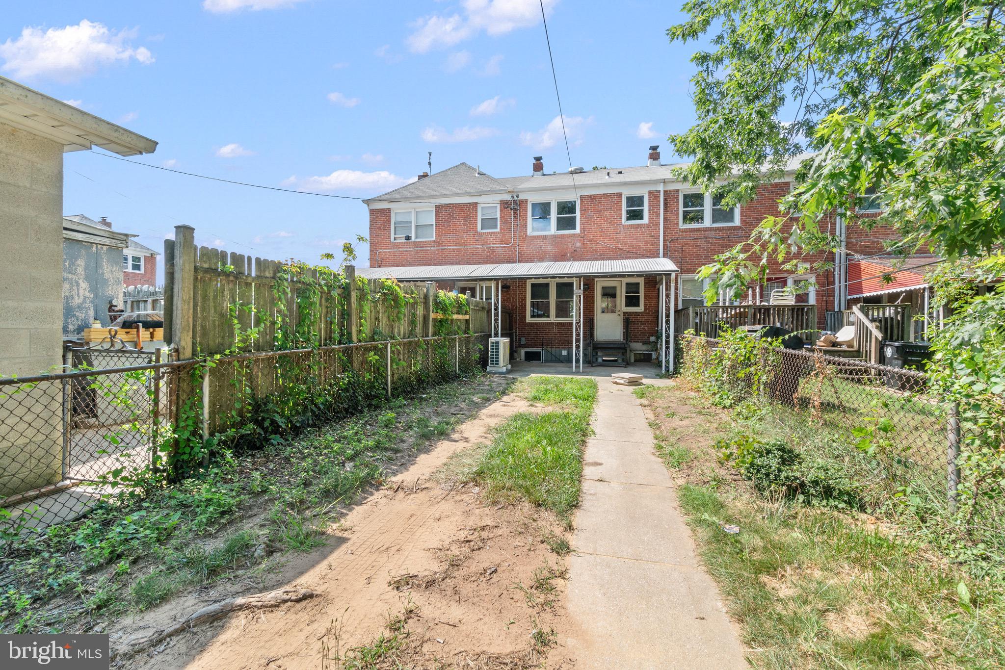2214 Hawthorne Road Baltimore, MD 21220 - Photo 27 of 28 a view of a brick house with a yard and plants