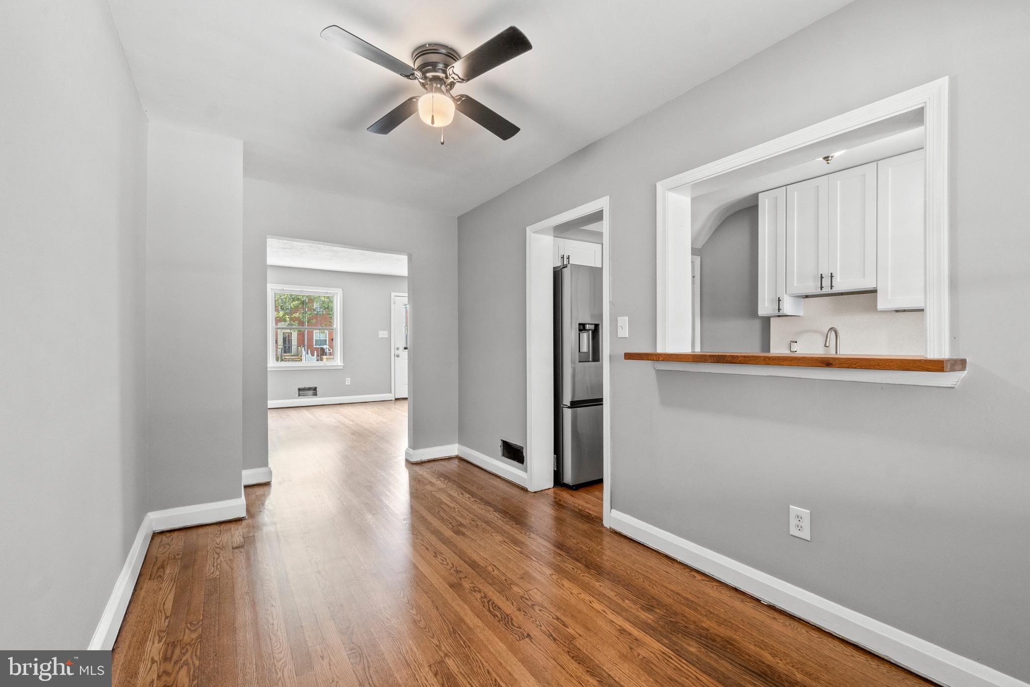 2214 Hawthorne Road Baltimore, MD 21220 - Photo 10 of 28 a view of a kitchen with wooden floor and a ceiling fan