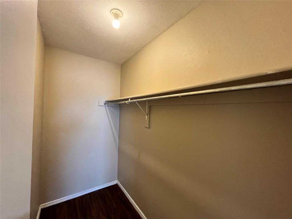 2526 West Prairie Street, Unit 108 Denton, TX 76201 - Photo 8 of 12 Here is a walk-in closet. Notice the long shelf and clothing rack.