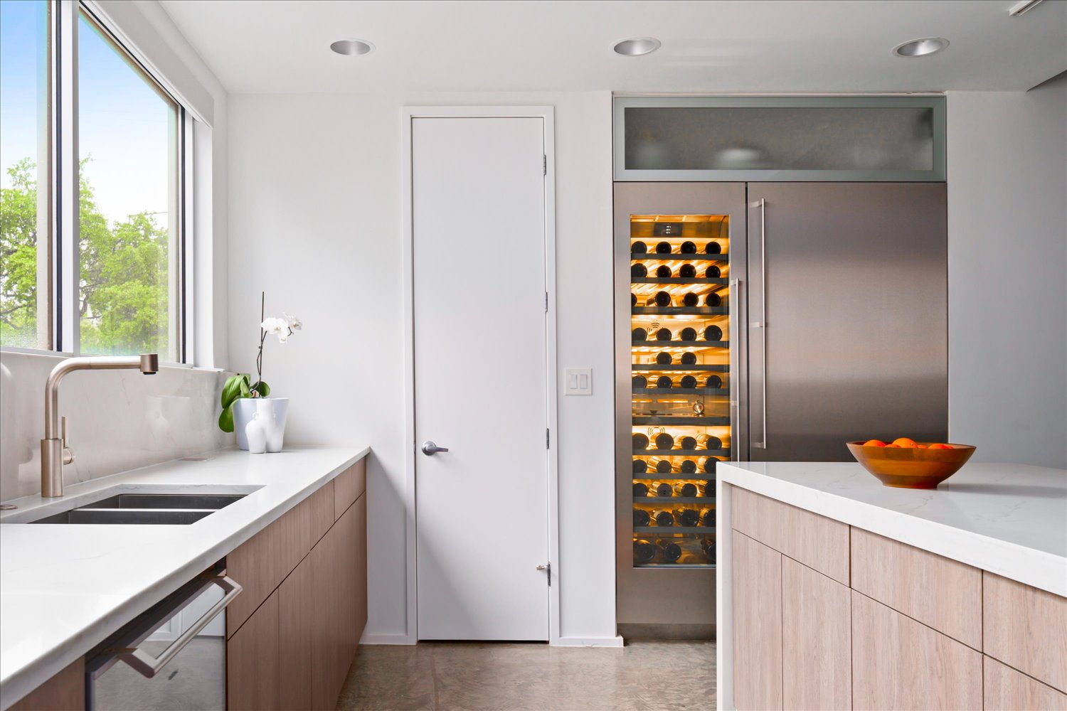 2301 South 5th Street, Unit 11 Austin, TX 78704 - Photo 9 of 24 Thoughtful details like a cookie sheet drawer and illuminated glass cabinetry reflect meticulous planning.