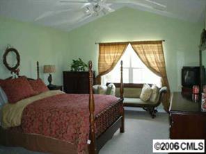 2341 Mirage Place Fort Mill, SC 29708 - Photo 7 of 8 a bedroom with a bed and a couch