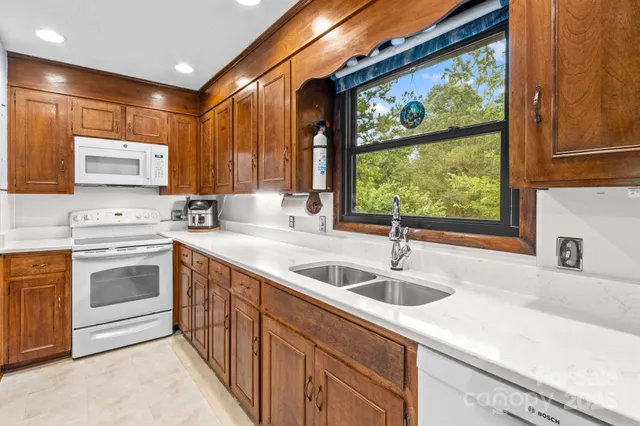 a kitchen with stainless steel appliances a sink stove and cabinets