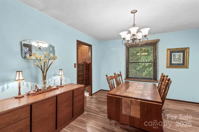 a living room with stainless steel appliances granite countertop furniture and window
