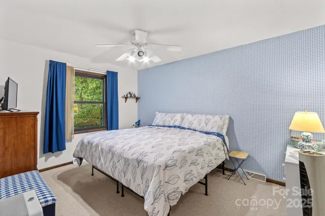 a bedroom with a bed dresser and a window