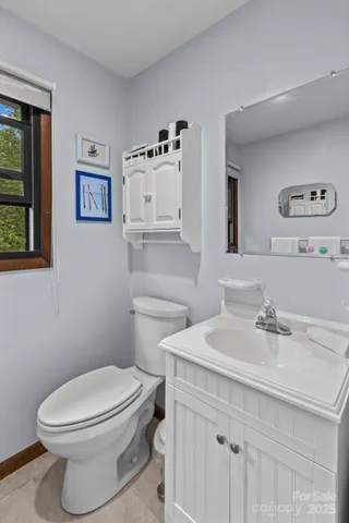 a bathroom with a sink mirror and toilet