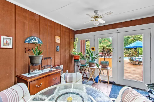a living room with furniture a chandelier and a window
