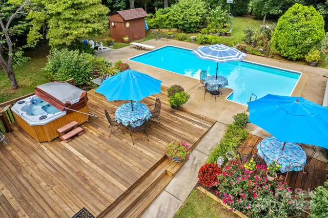 a view of a patio with chairs and umbrellas on a wooden deck