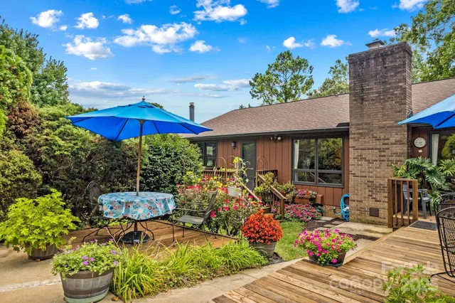 a view of a house with backyard sitting area and garden