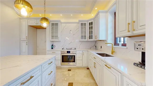 a kitchen with stainless steel appliances granite countertop a sink a stove and a refrigerator