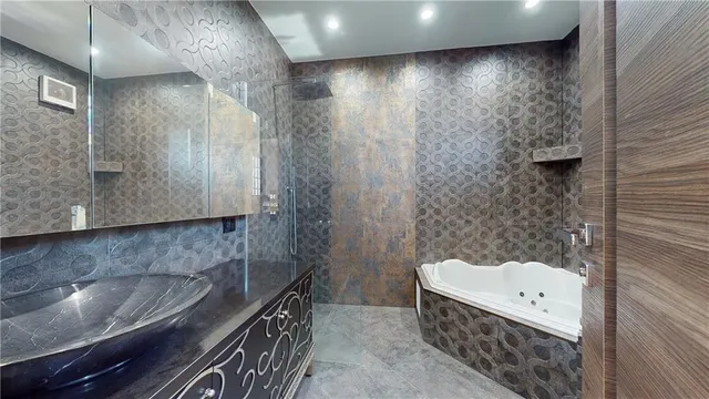 a bathroom with a bathtub and shower