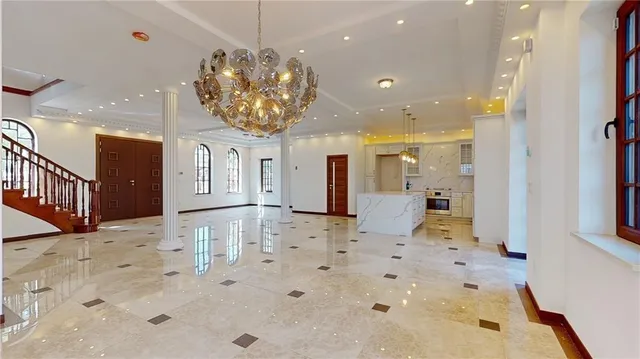 a view of a kitchen with kitchen island stainless steel appliances a refrigerator a sink dishwasher with a dining table and chairs