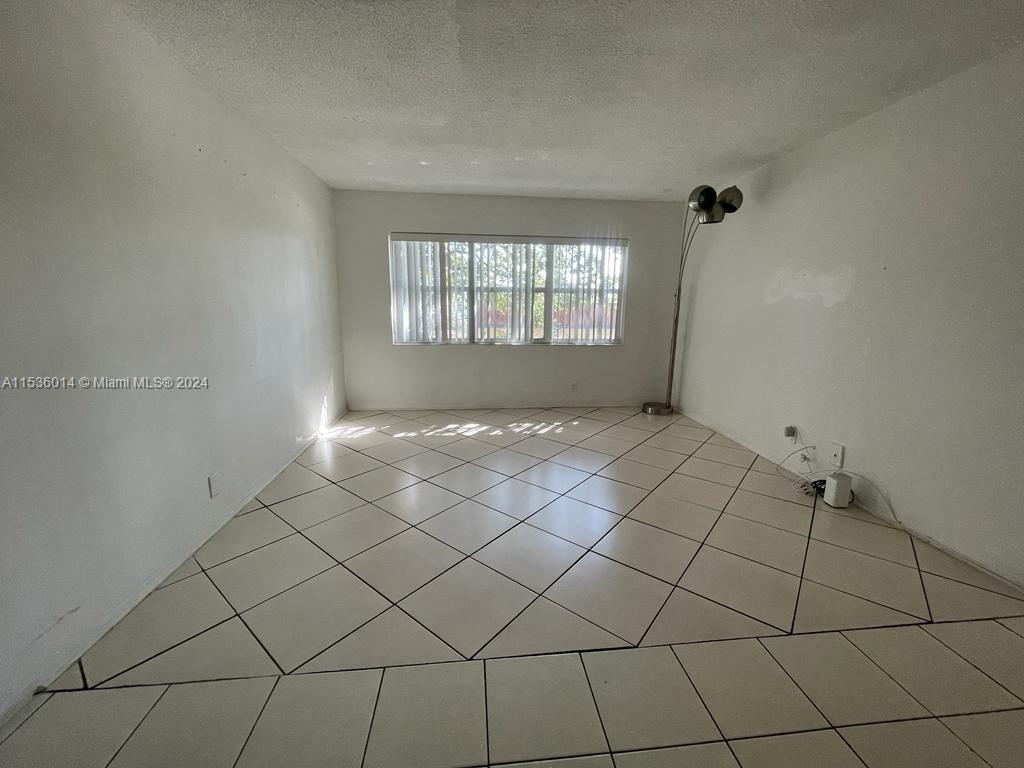 Garden Isles Pompano Beach, FL 33060 - Photo 3 of 9 a view of an empty room and window
