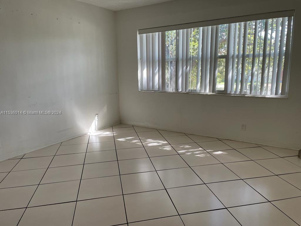 Garden Isles Pompano Beach, FL 33060 - Photo 4 of 9 a view of an empty room and window