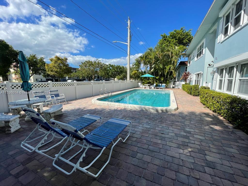 Garden Isles Pompano Beach, FL 33060 - Photo 8 of 9 a view of backyard with swimming pool and outdoor seating