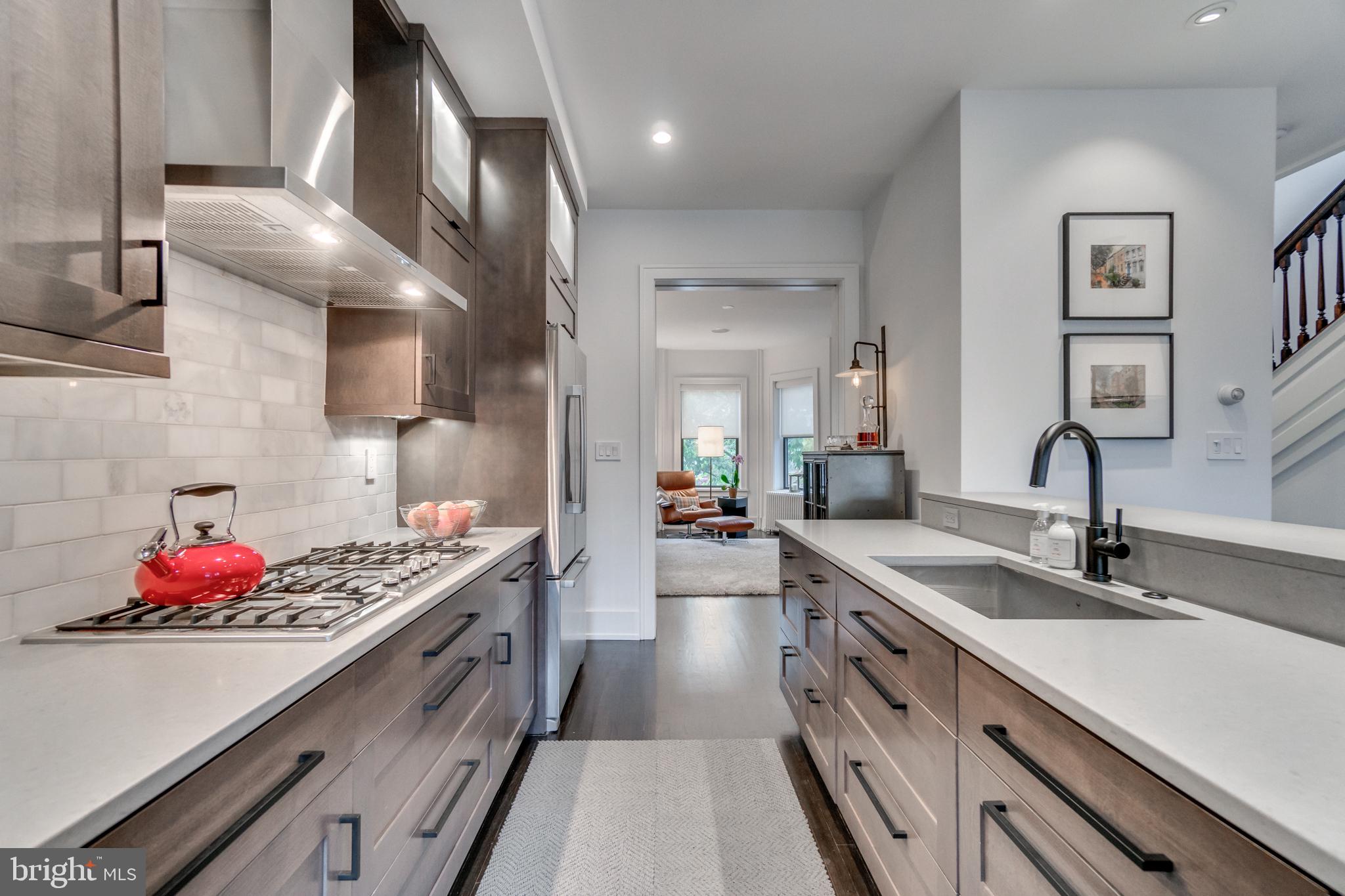 1009 Irving Street Northwest Washington, DC 20010 - Photo 10 of 33 Sleek modern kitchen with open layout.