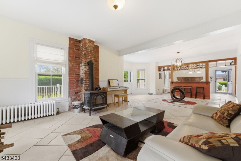 61 New Street Hampton, NJ 08827 - Photo 23 of 45 a living room with furniture a fireplace and a table