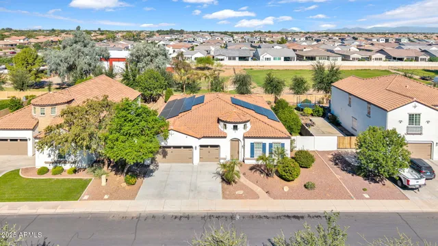 an aerial view of a house with a garden and mountain view in back