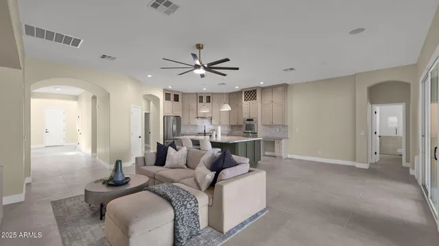 a kitchen with kitchen island a sink stainless steel appliances and cabinets