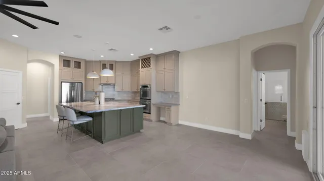 a kitchen with center island table and chairs