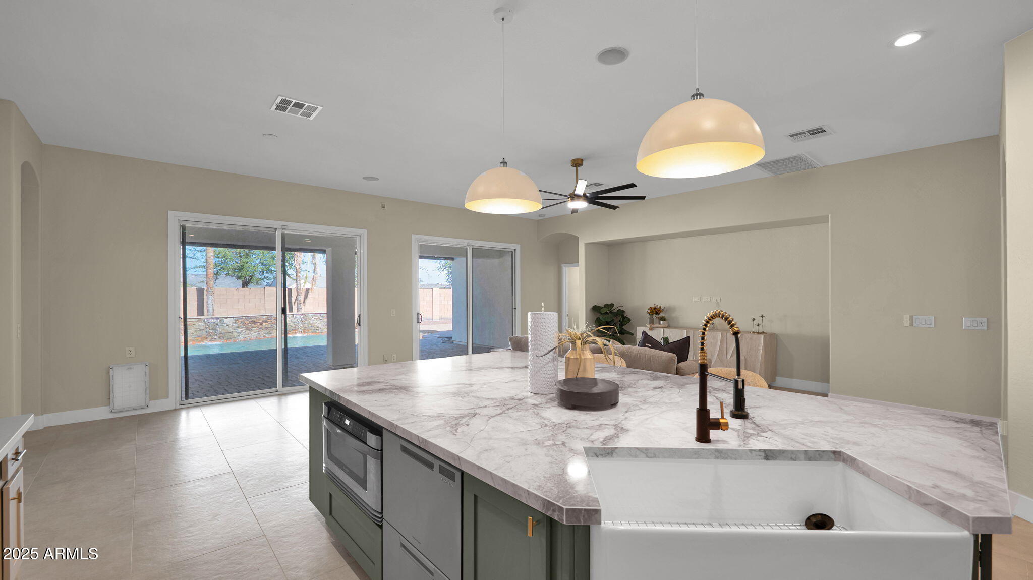 4060 East Canyon Way Chandler, AZ 85249 - Photo 21 of 55 a kitchen with kitchen island a sink and living room view