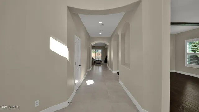 a view of a hallway with wooden floor and a living room