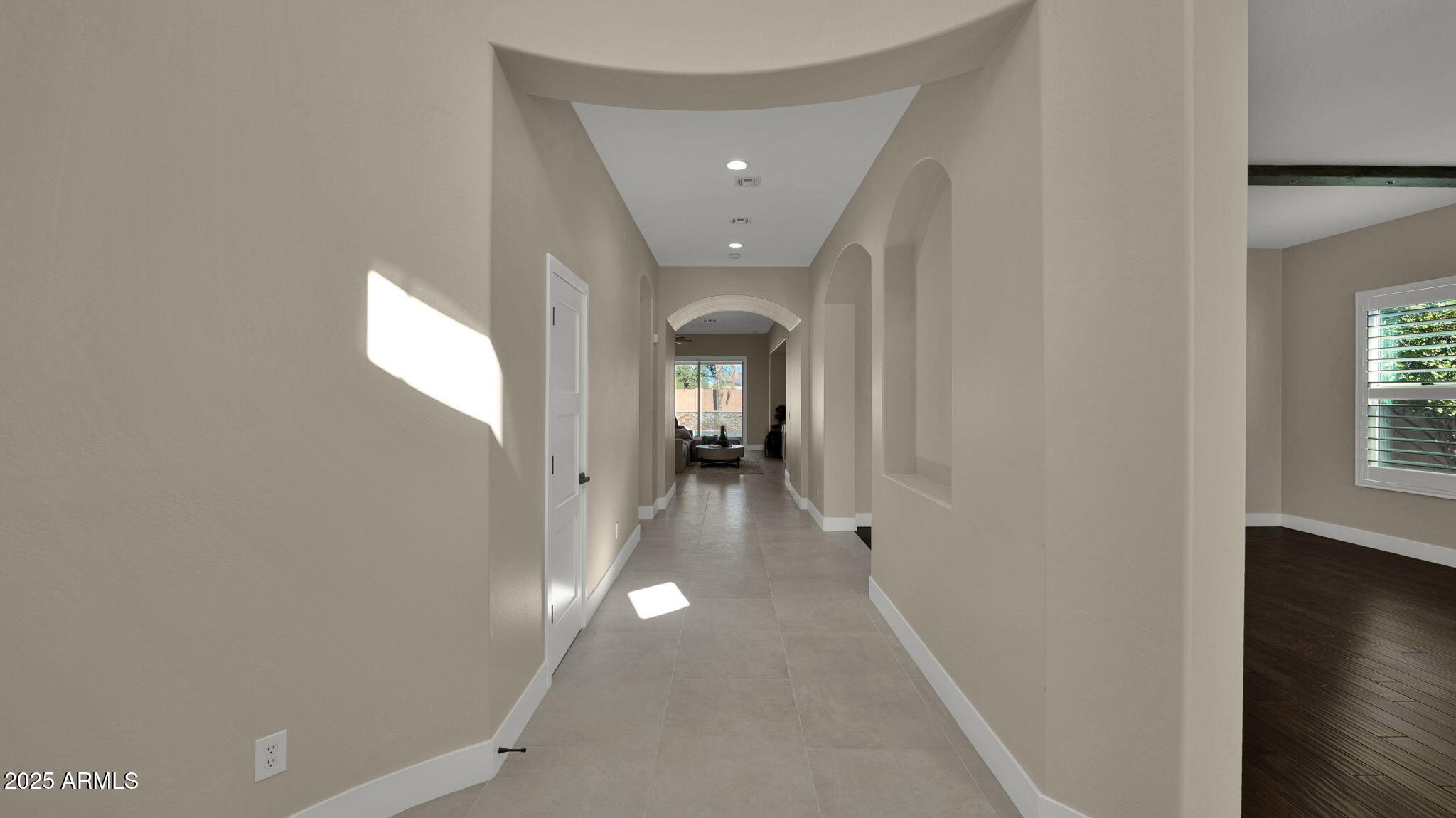 4060 East Canyon Way Chandler, AZ 85249 - Photo 4 of 55 a view of a hallway with wooden floor and a living room