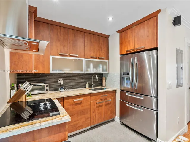 a kitchen with a refrigerator and a sink