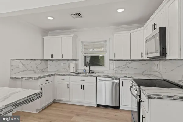 a kitchen with a sink stove and cabinets