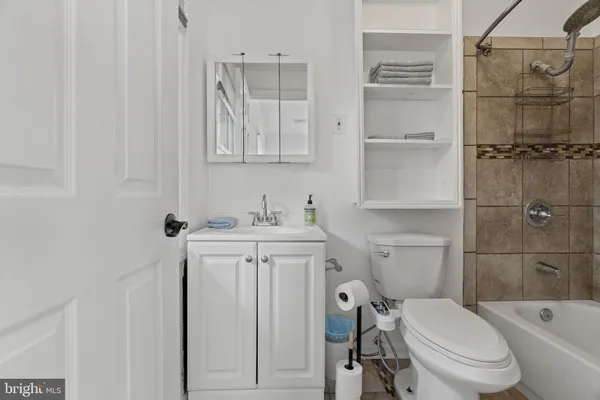 a bath tub sitting next to a shower
