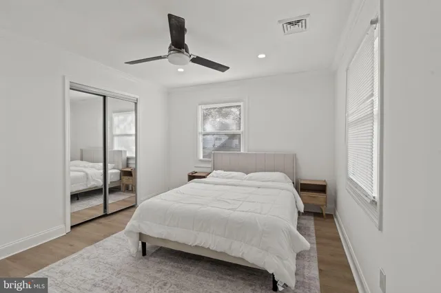 a bathroom with a sink a toilet a mirror and shower