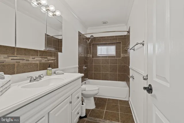 a bathroom with a tub a toilet and a sink