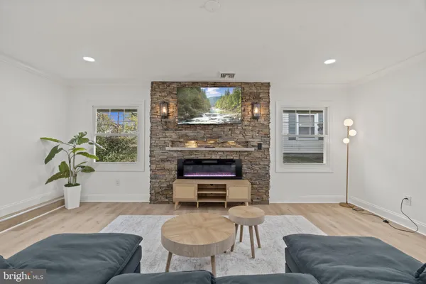 a living room with furniture and a fireplace