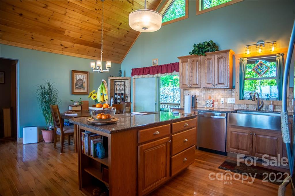 603 Wild Turkey Road Ferguson, NC 28624 - Photo 12 of 46 a kitchen with stainless steel appliances granite countertop a stove a sink dishwasher and cabinets with wooden floor