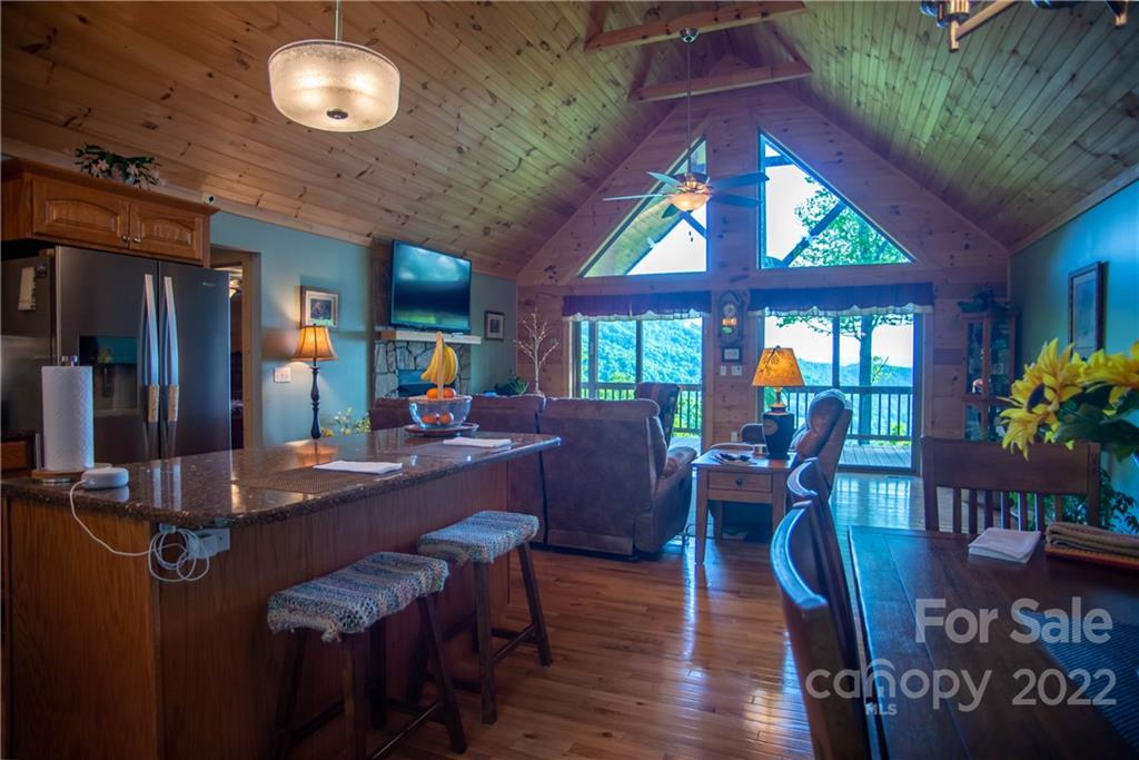 603 Wild Turkey Road Ferguson, NC 28624 - Photo 16 of 46 a view of a dining room with furniture window and wooden floor