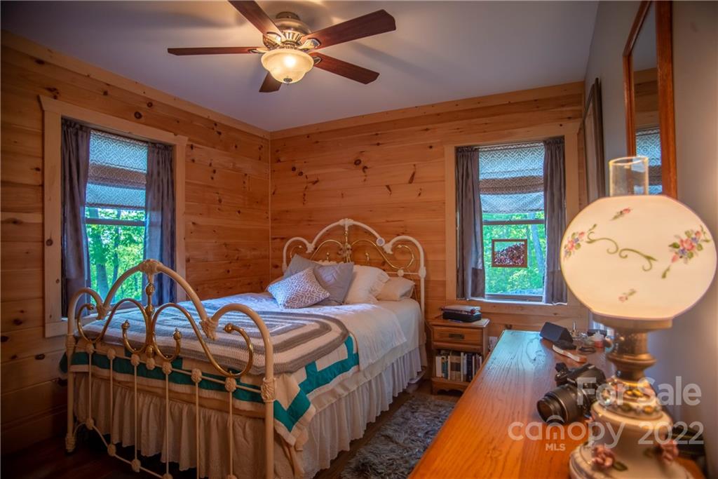 603 Wild Turkey Road Ferguson, NC 28624 - Photo 28 of 46 a bed room with a bed mirror and a window