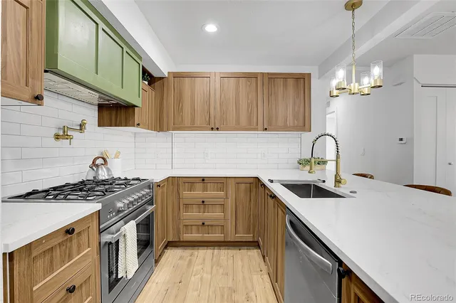 a kitchen that has a sink and a stove
