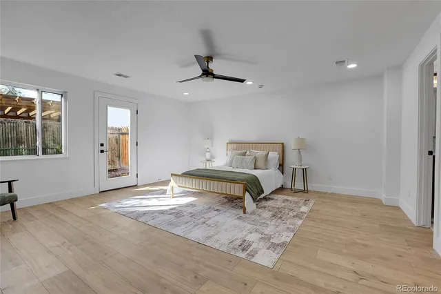 a bedroom with a bed and a ceiling fan