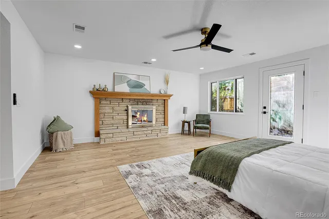 a spacious bedroom with a bed and a ceiling fan