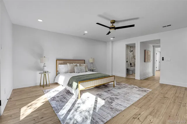 a bedroom with a bed and wooden floor