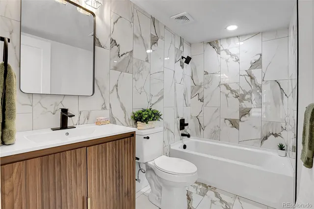 a bathroom with a sink a toilet and a bathtub