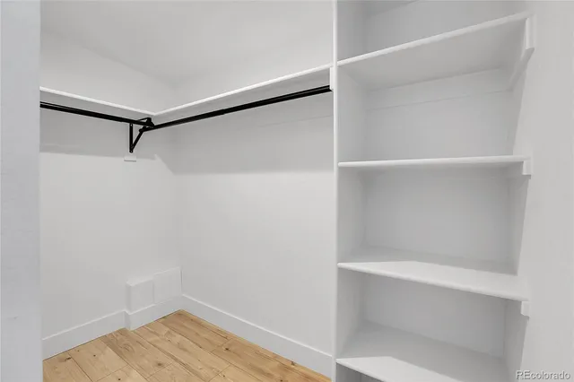a view of walk in closet with empty racks