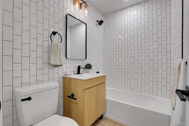 a bathroom with a sink mirror toilet and bathtub