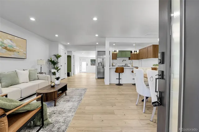 a living room with furniture and a chandelier