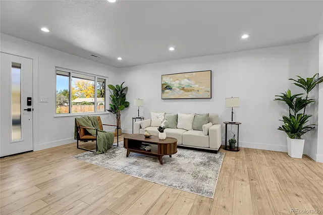 a living room with furniture and wooden floor