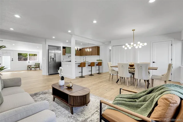 a living room with furniture and a chandelier
