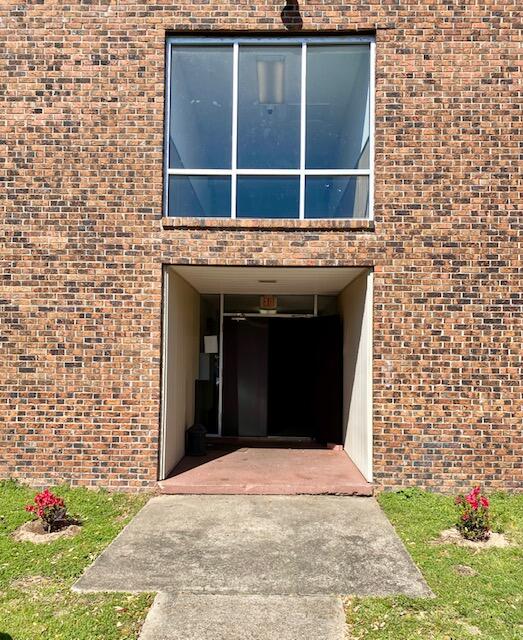 605 Colonial Drive, Unit 5 Fort Walton Beach, FL 32547 - Photo 2 of 31 a view of a brick house with a large window