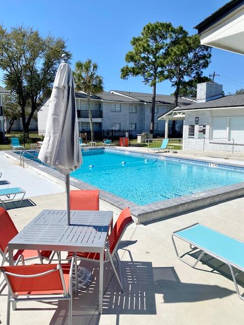 605 Colonial Drive, Unit 5 Fort Walton Beach, FL 32547 - Photo 29 of 31 swimming pool view with a seating space and garden