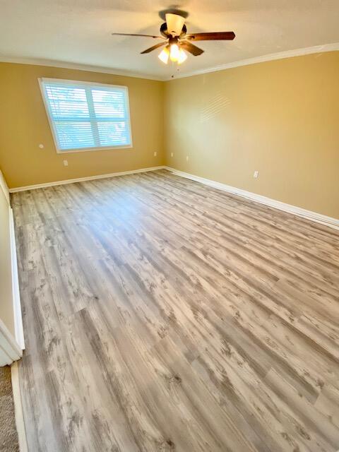 605 Colonial Drive, Unit 5 Fort Walton Beach, FL 32547 - Photo 6 of 31 an empty room with a window and a ceiling fan