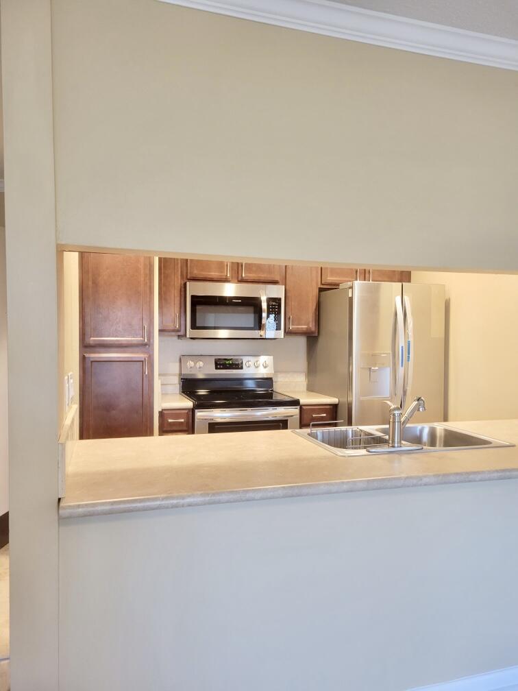 605 Colonial Drive, Unit 5 Fort Walton Beach, FL 32547 - Photo 7 of 31 a kitchen with stainless steel appliances a sink and a microwave